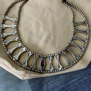 Uno de 50 cleopatra style necklace with purple stone set in middle.
